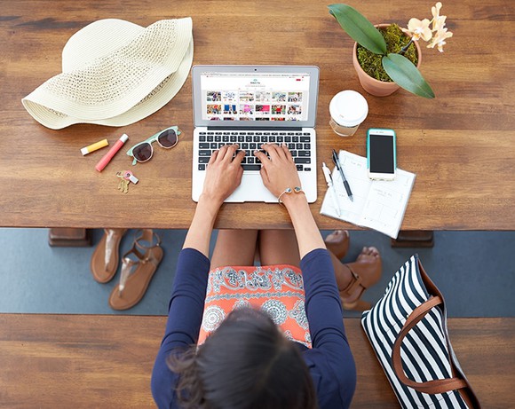Woman browsing Stitch Fix website on laptop.