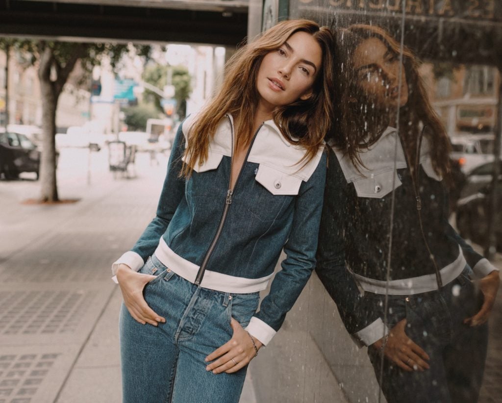 Model wearing denim top and jeans.