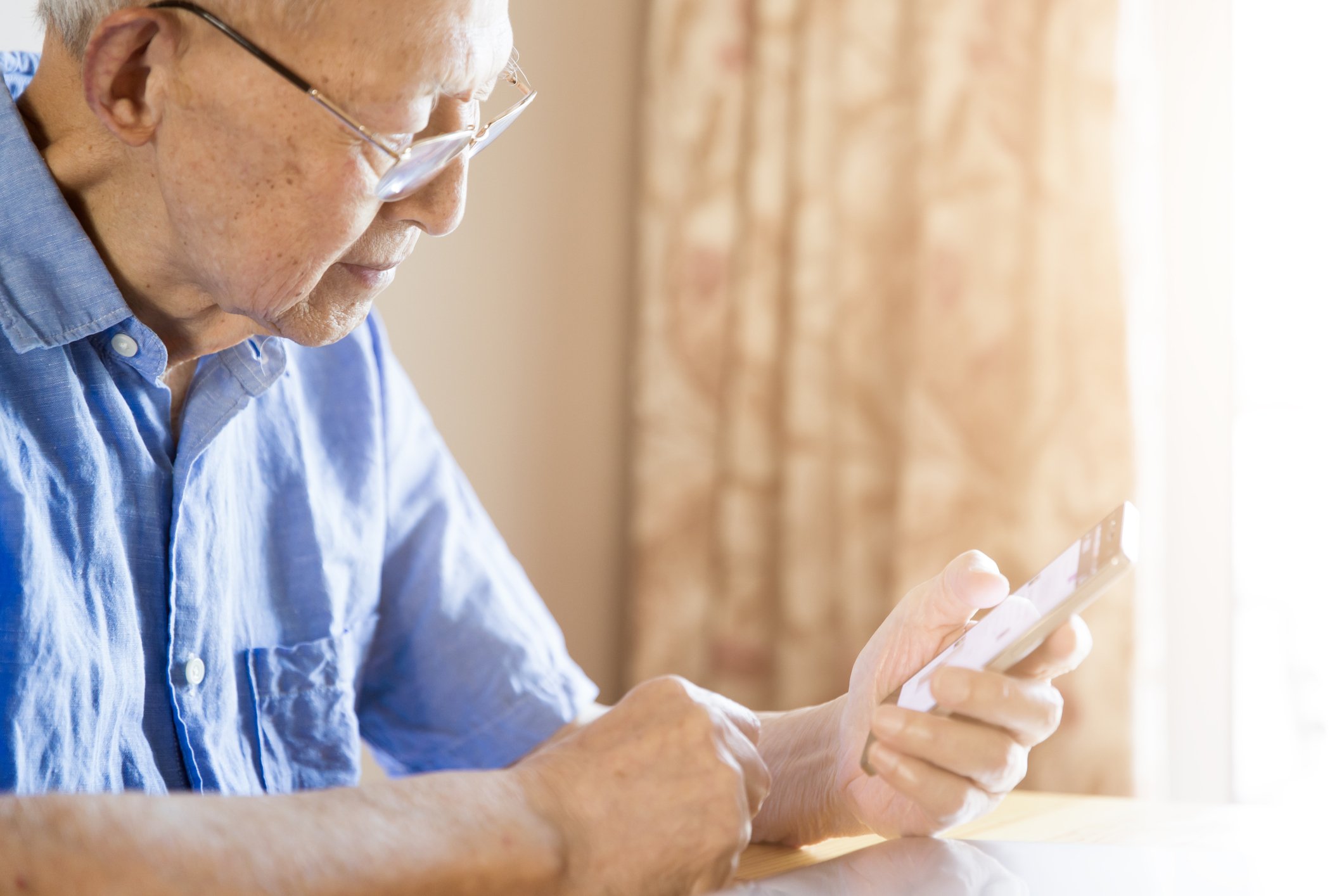 Older man holding a phone