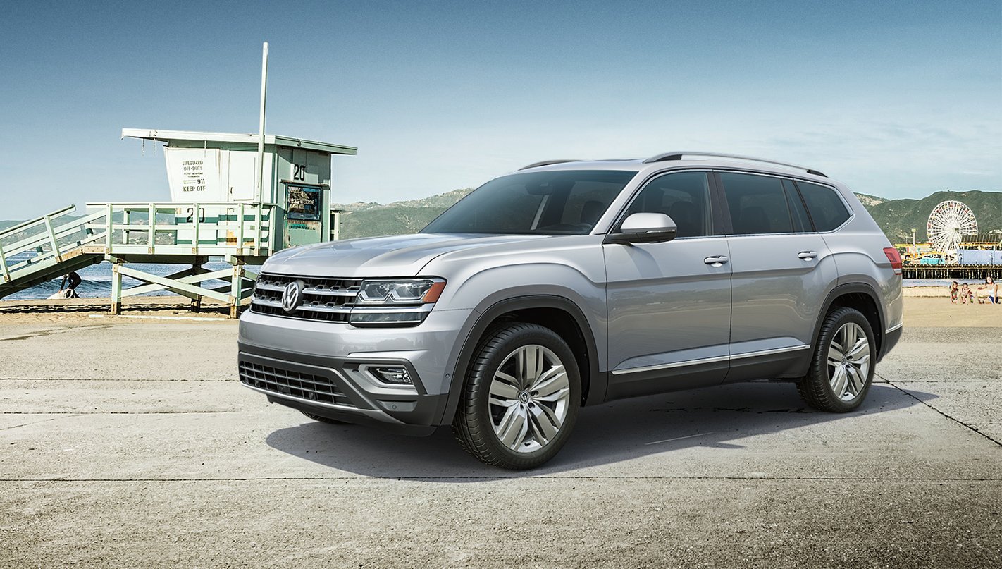 A 2019 Volkswagen Atlas, a U.S.-made 7-passenger SUV, parked near a beach.