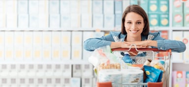 Smiling Woman Leaning on Grocery Cart
