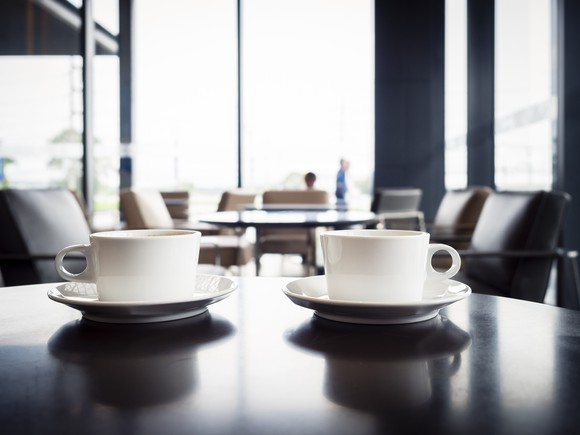 Close-up of coffee cups in an airport departure lounge.