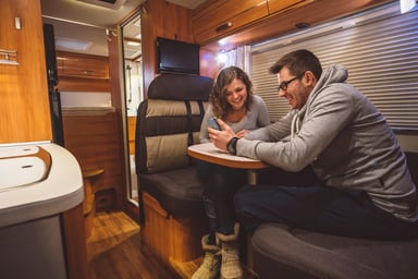 Couple Sitting Inside a Contemporary RV