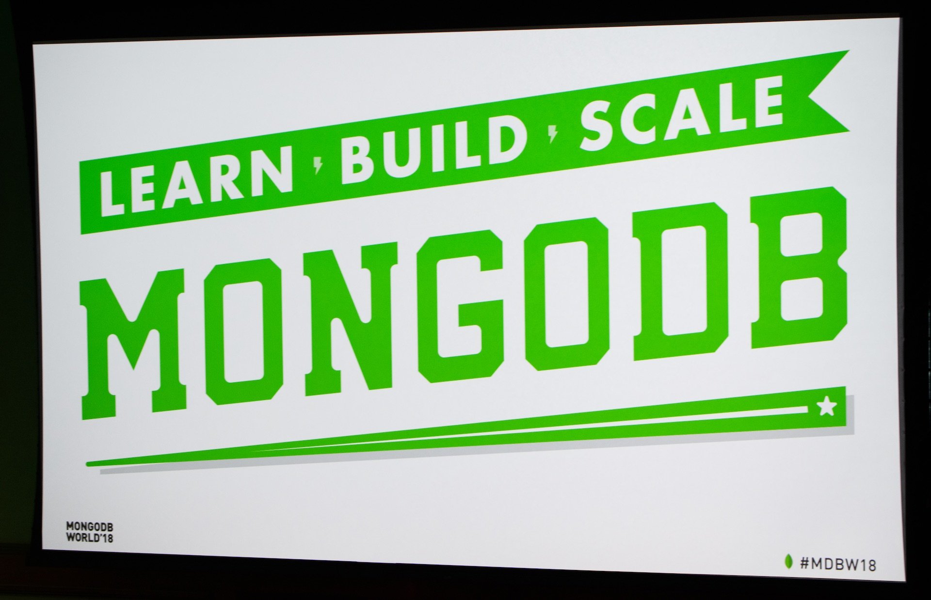 Poster with MongoDB name and logo in green on a white background.