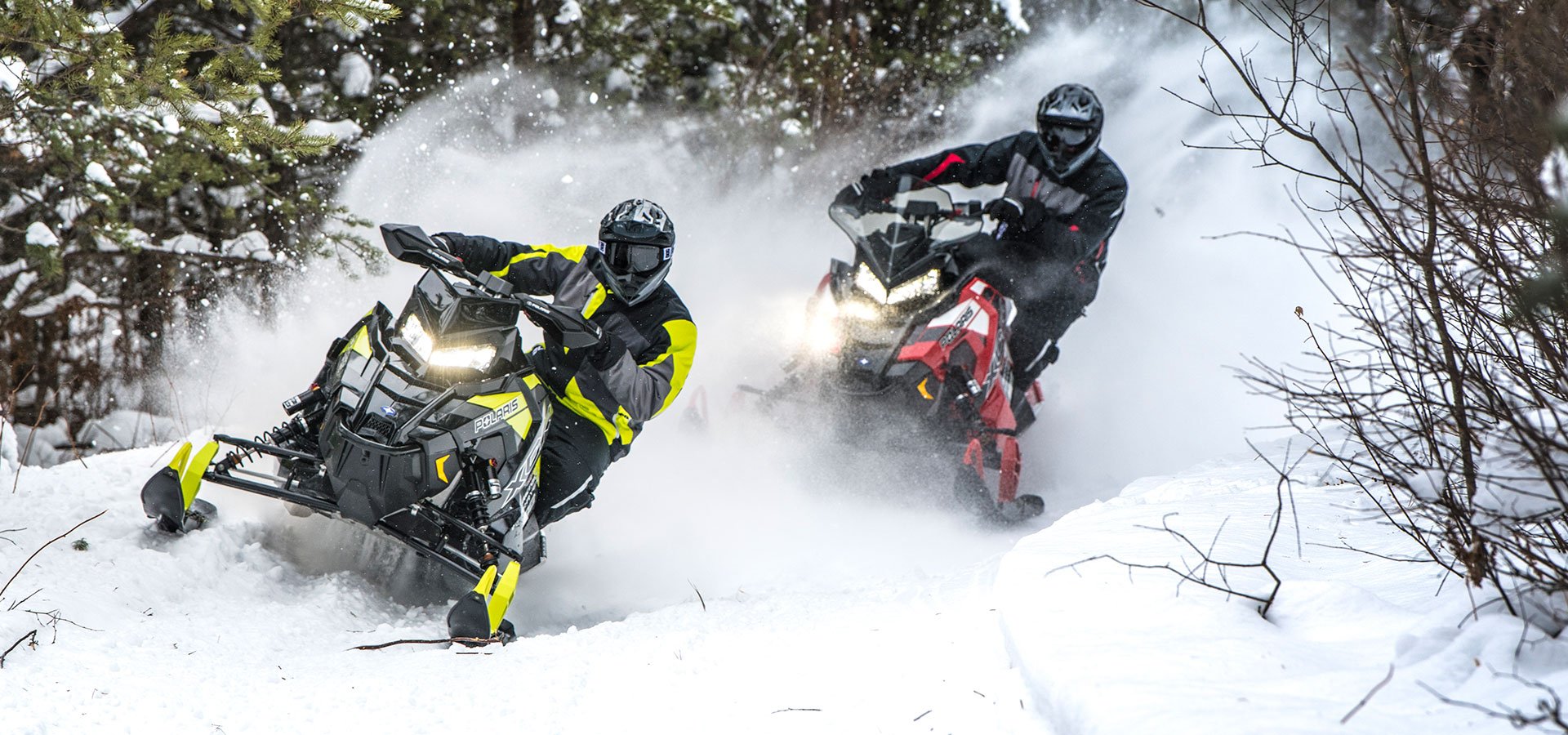 Snowmobiles racing through snow