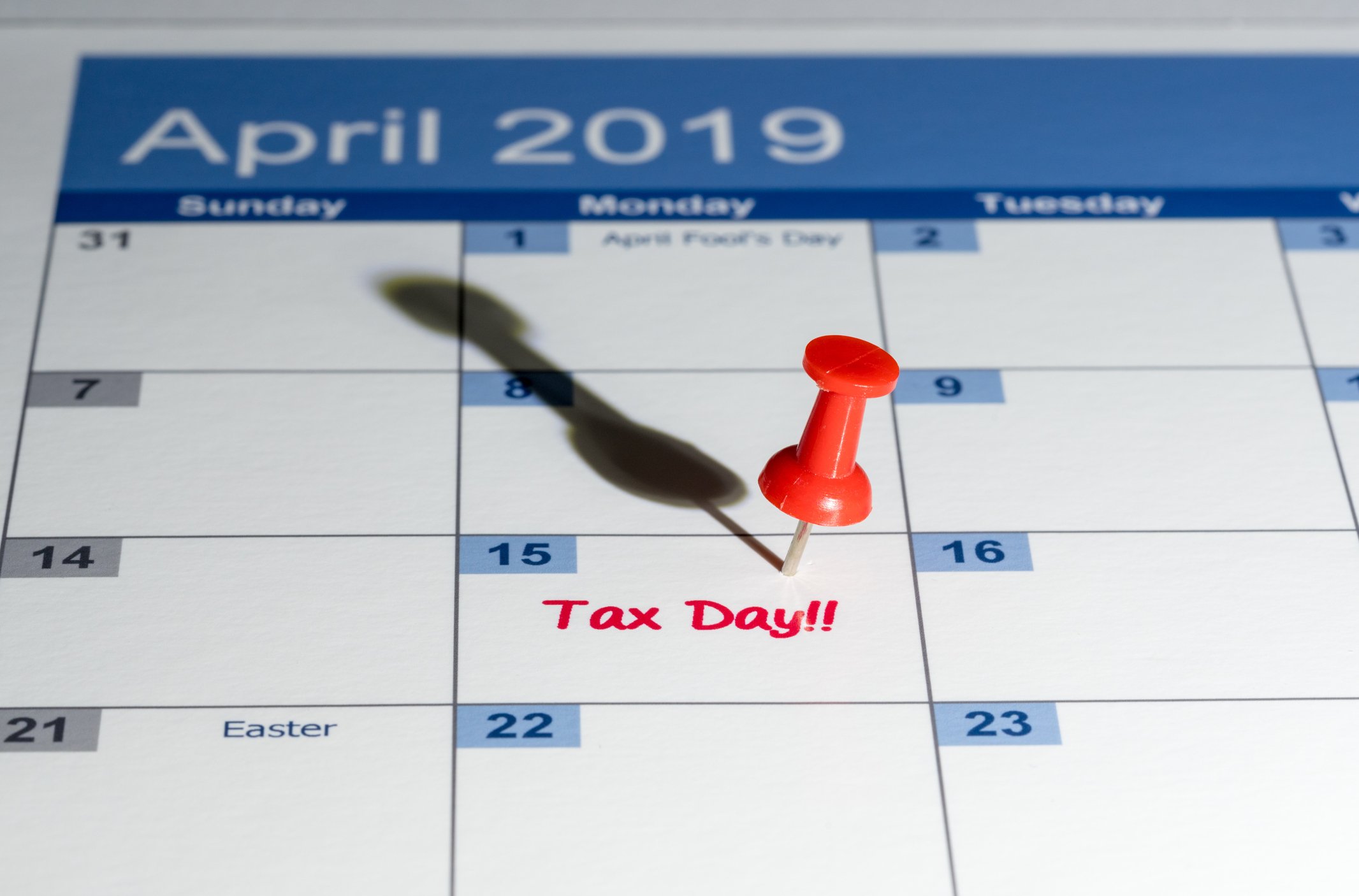 April 2019 calendar with pin on 4/15 and the words tax day written in red