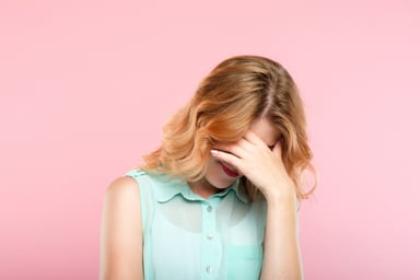 woman covering her face_GettyImages-1046087252