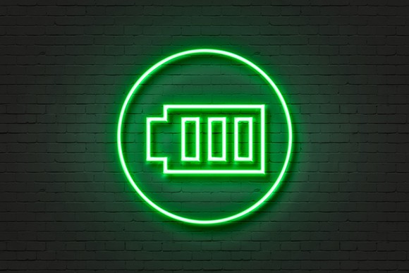 A green neon light displaying a battery icon.