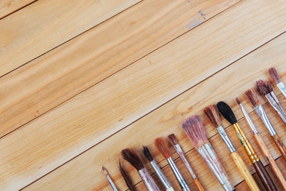 Various artist paintbrushes on a table.