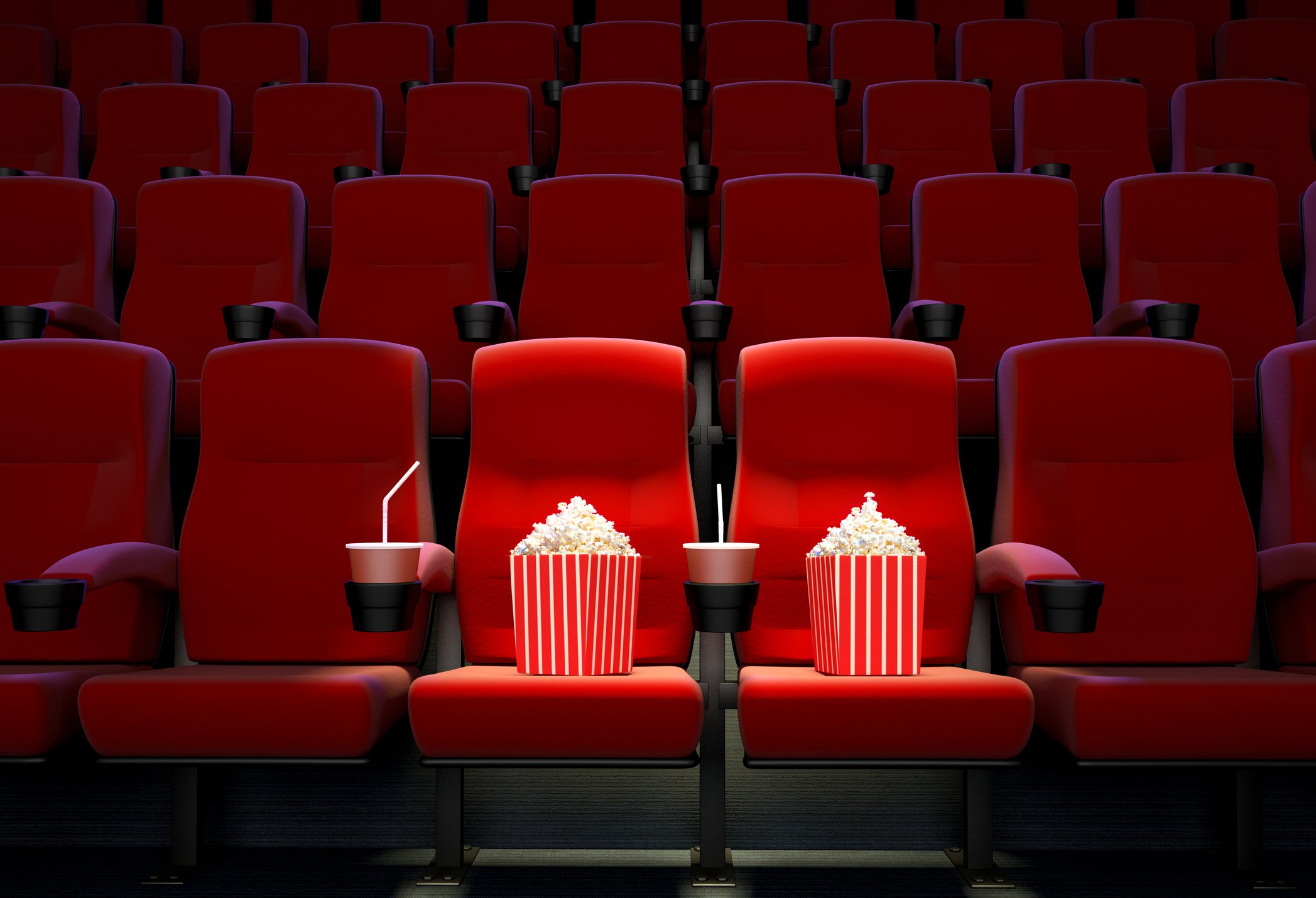Soda and popcorn on empty movie theater seats