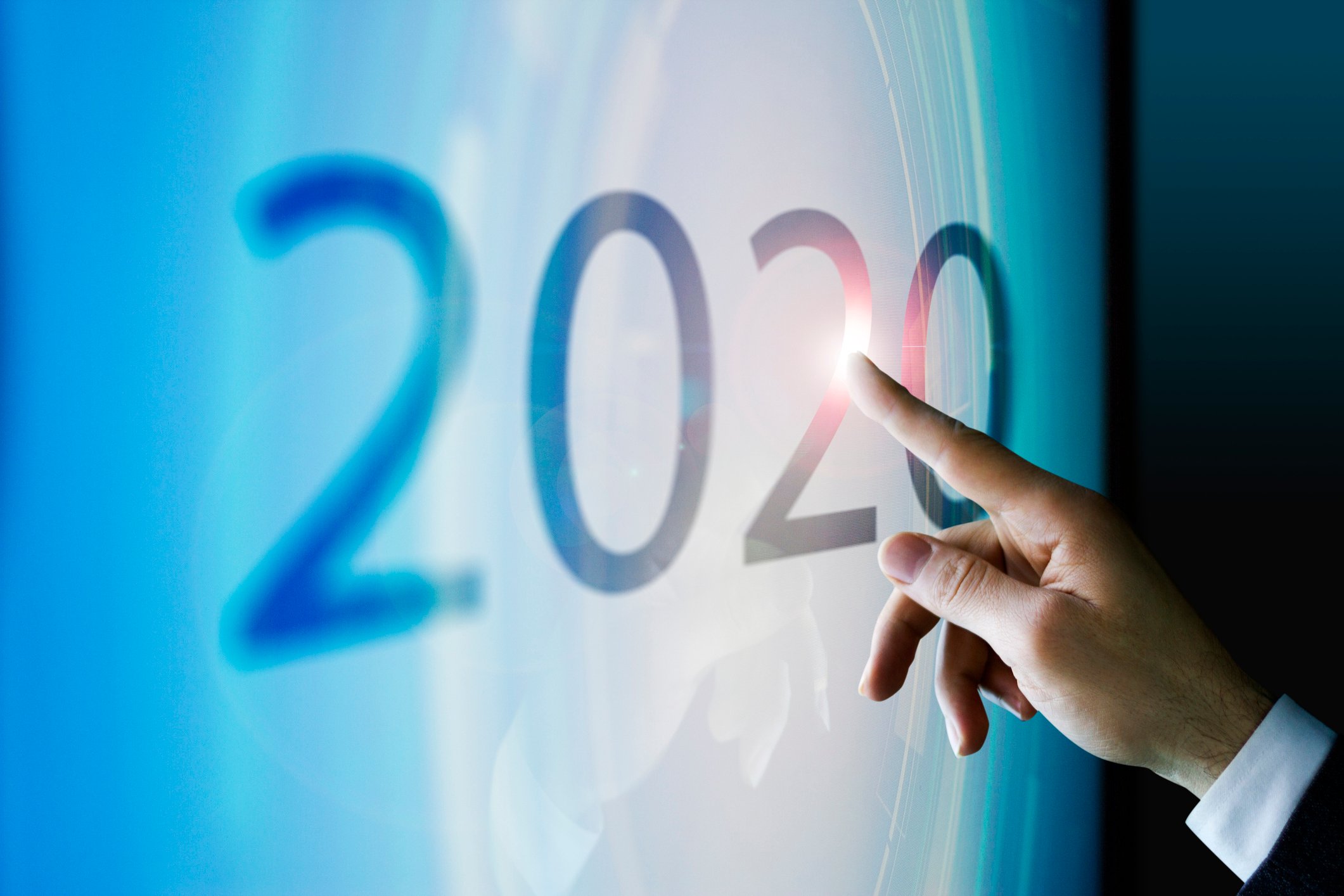 Finger touching 2020 on touchscreen