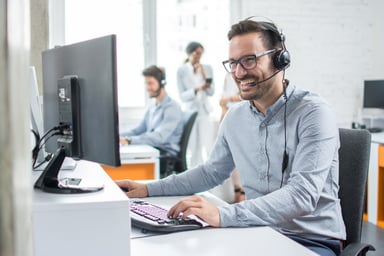 smiling man with headset_GettyImages-925689844