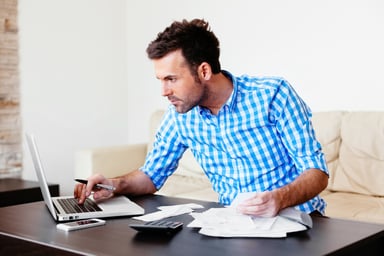 man calculating expenses_GettyImages-474635864