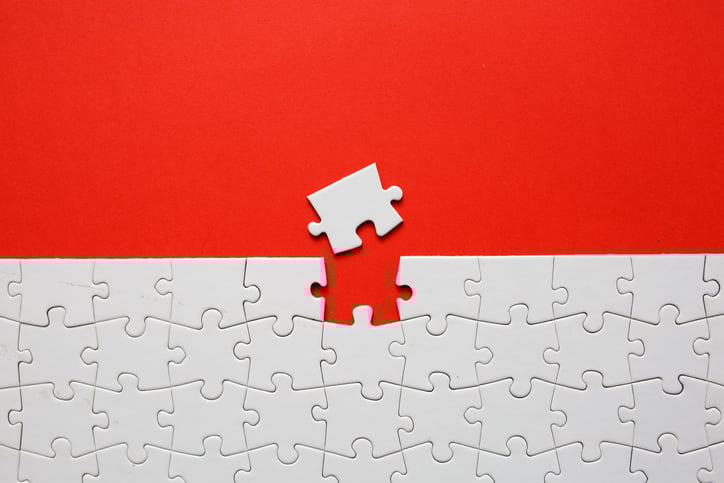 The last piece of a puzzle being inserted.