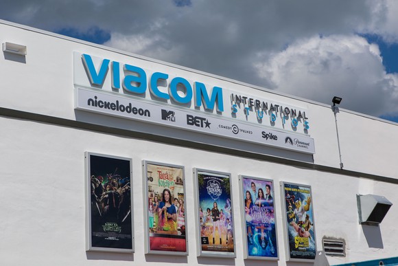 Viacom international studio building with five movie posters and a partly cloudy sky above.