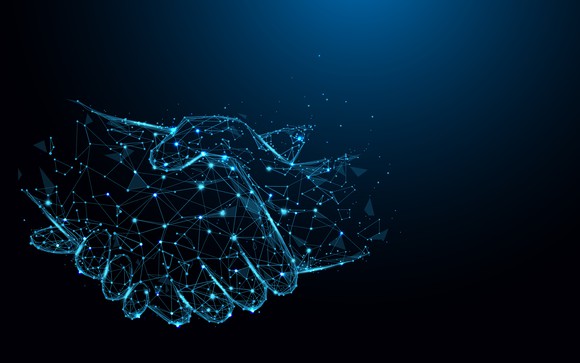 A handshake between two hands comprised of network connections.