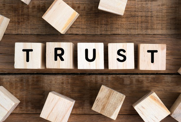 The word "trust" spelled out on wooden blocks.