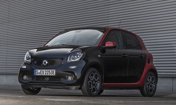 A black and red Smart EQ ForFour, a small four-seat electric car.