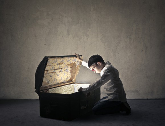 A person opening a treasure chest.