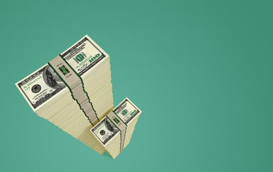 2 stacks of $100 bills