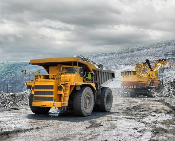 A back hoe and hauling truck in an iron ore mine. 