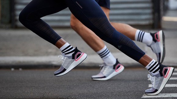 Two runners running in Adidas UltraBoost shoes.