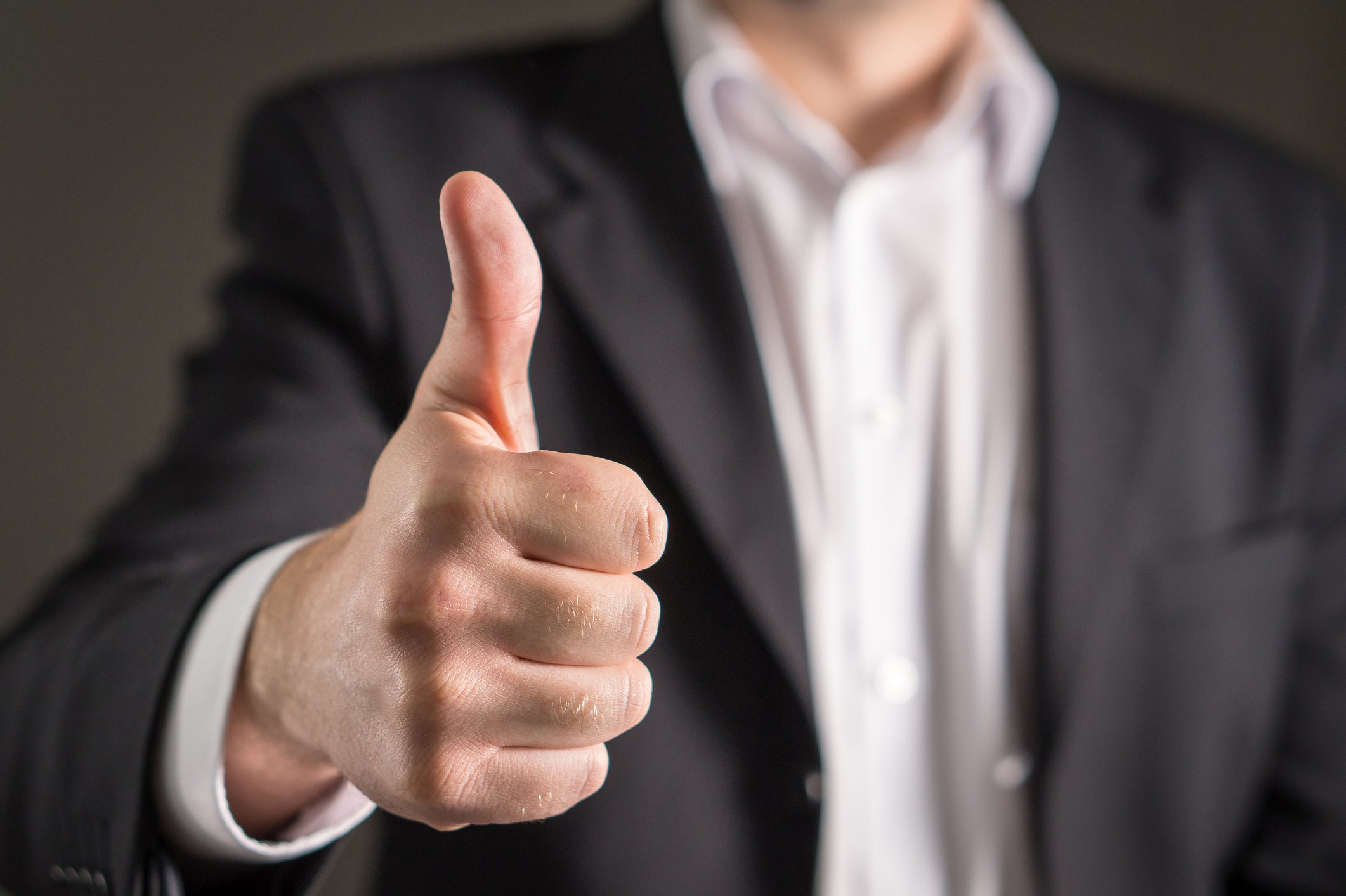 Businessman with one thumb up