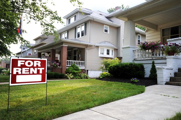 Home with rental sign in the front yard.
