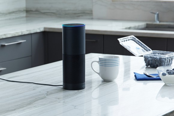 An Amazon Echo sits on a kitchen counter.