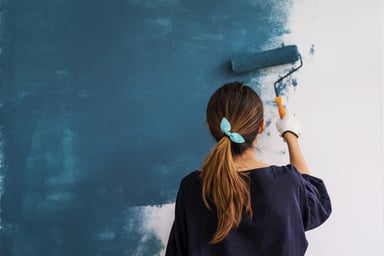 Woman Painting a Wall Blue