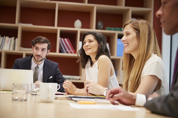 Several people at a meeting in a contemporary office space