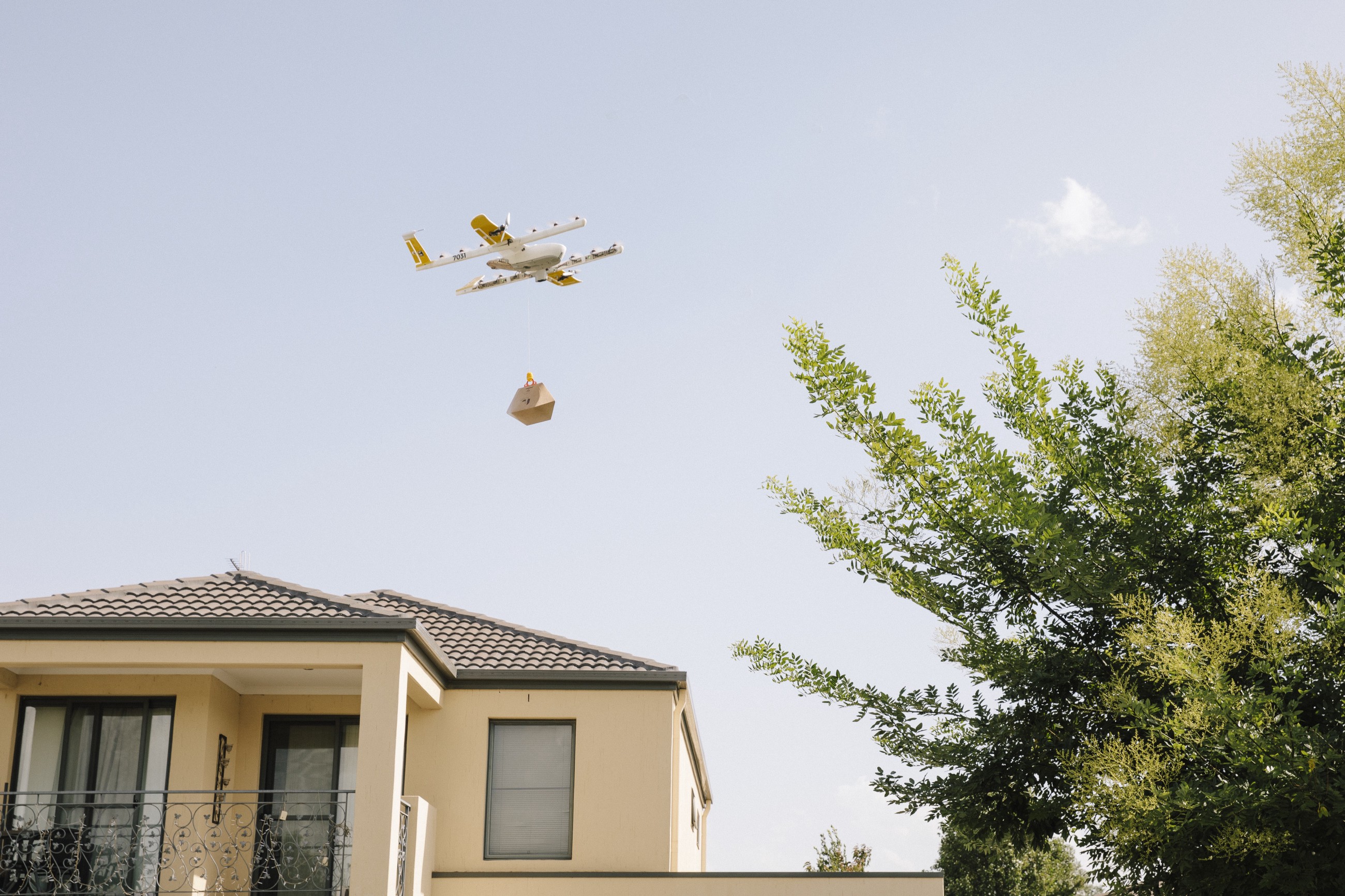 A delivery drone flying over a house