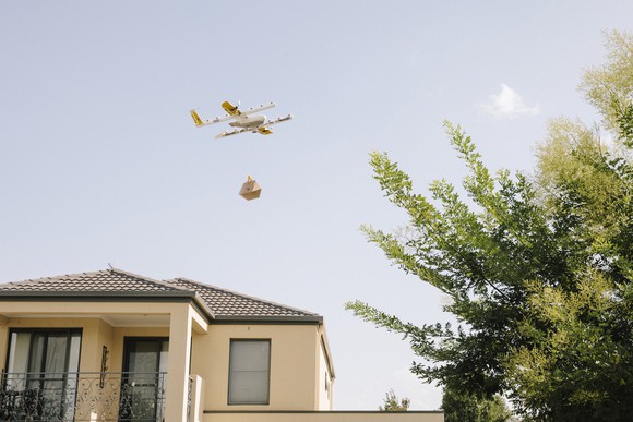 A delivery drone flying over a house