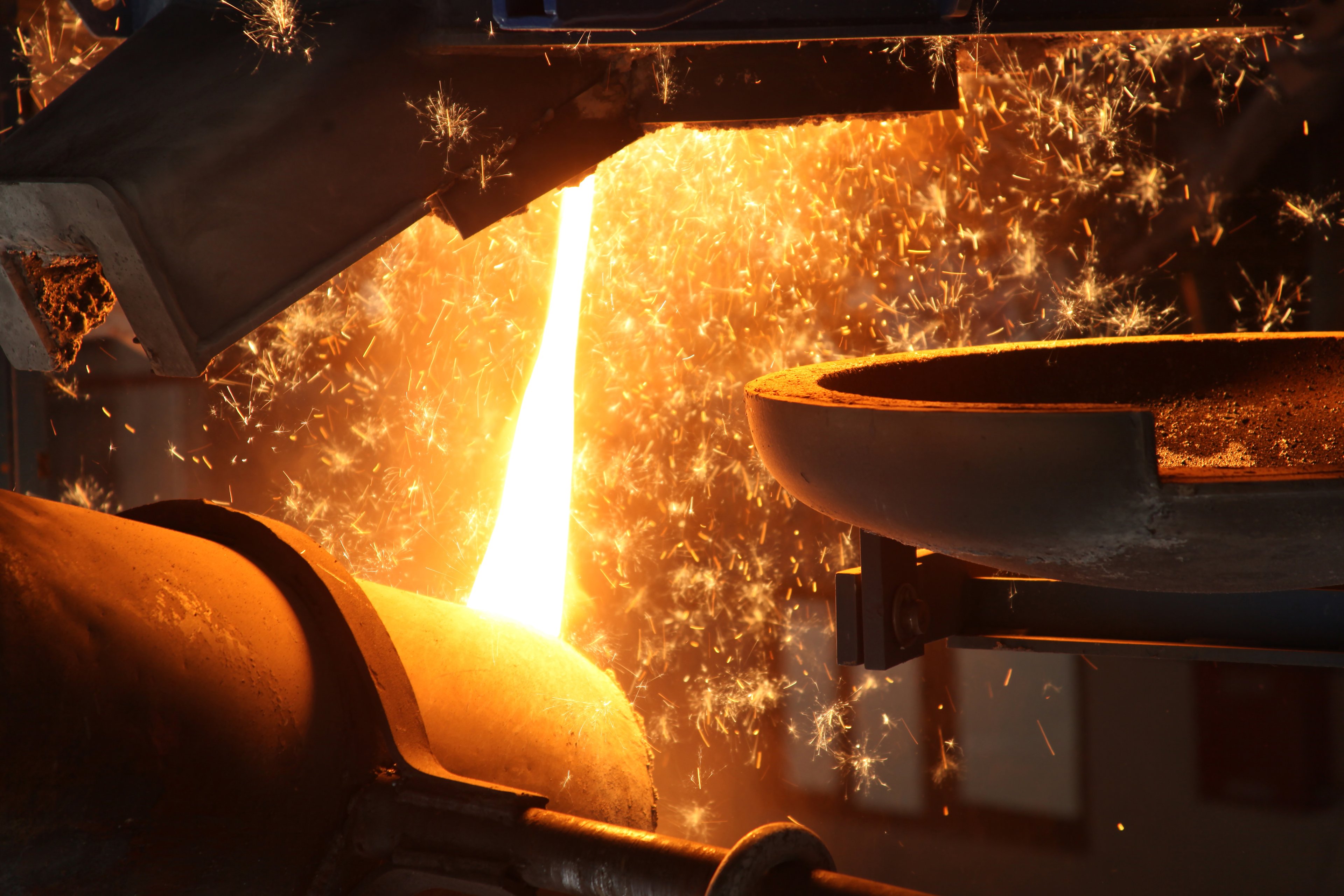 Hot metal is poured between machines.
