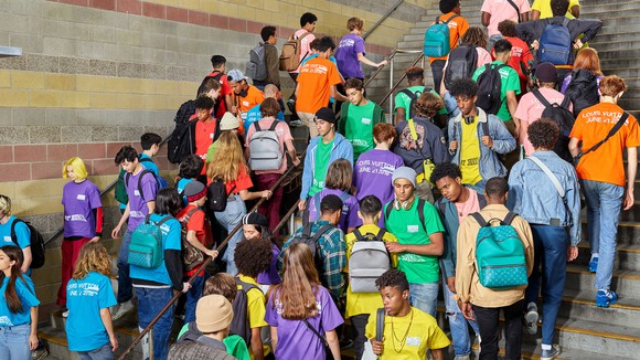 Teens wearing Louis Vuitton's Taigarama leather bags.
