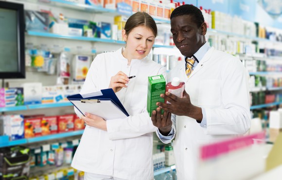 A male and a female pharmacist in a store
