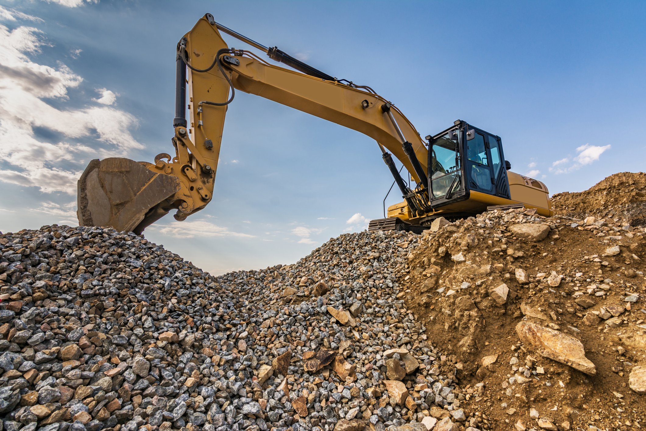 Excavator digging in gravel