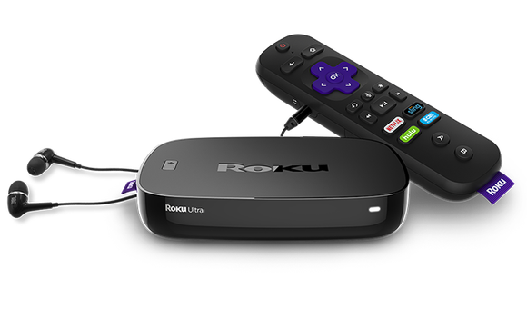 A shot of Roku's Ultra streaming video players with a remote and ear buds.