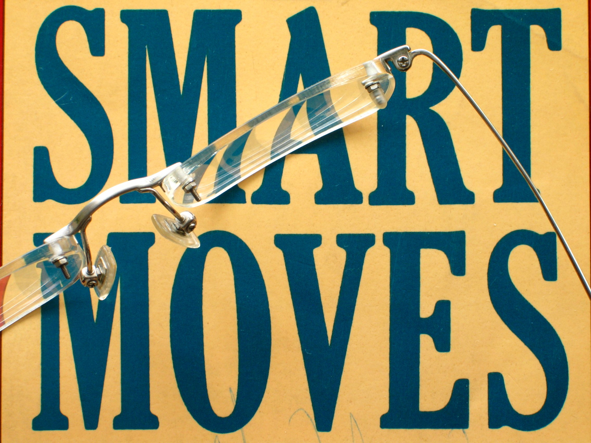 The words smart moves are printed, and on top of them is a pair of glasses.