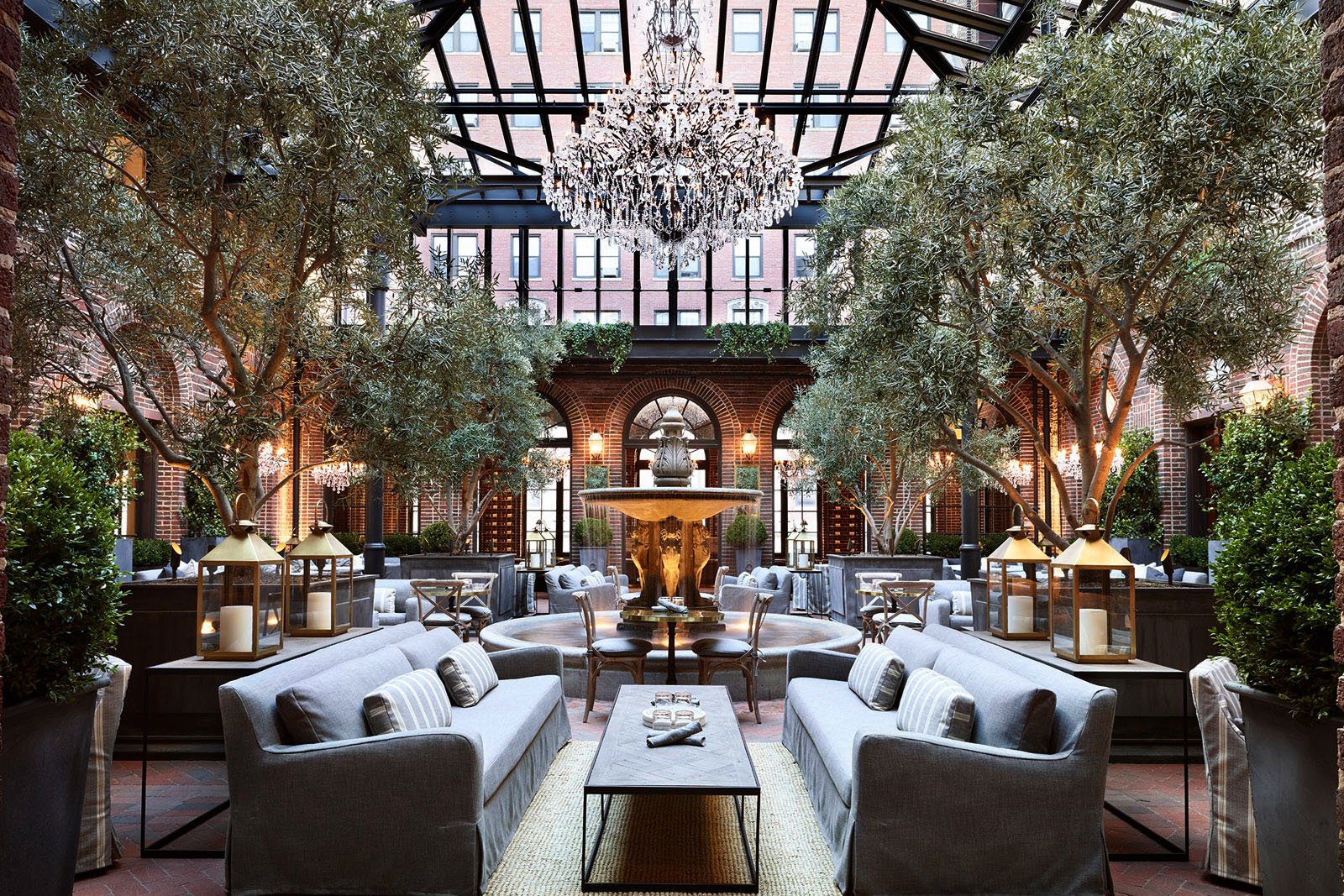 A photo of RH's Chicago Design Gallery with premium decor, including furniture, a fountain, and chandelier