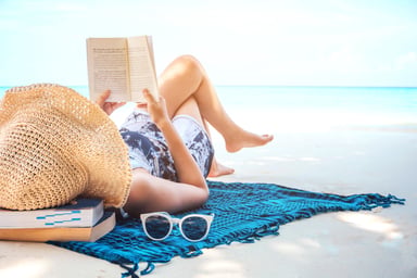 woman reading on beach_GettyImages-942466852