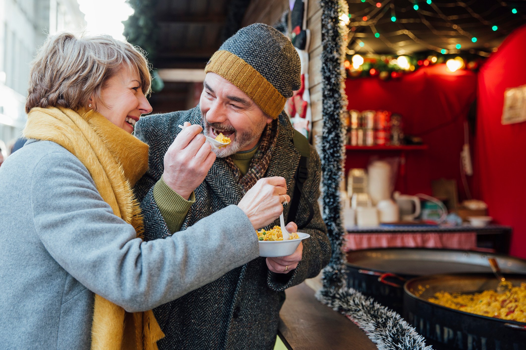 Senior couple sharing a bowl of rice outdoors