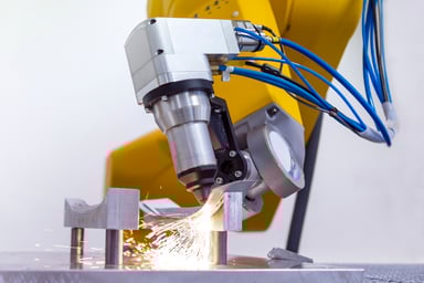 Laser on robotic arm cutting metal