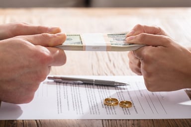 Couple fighting over money over divorce papers