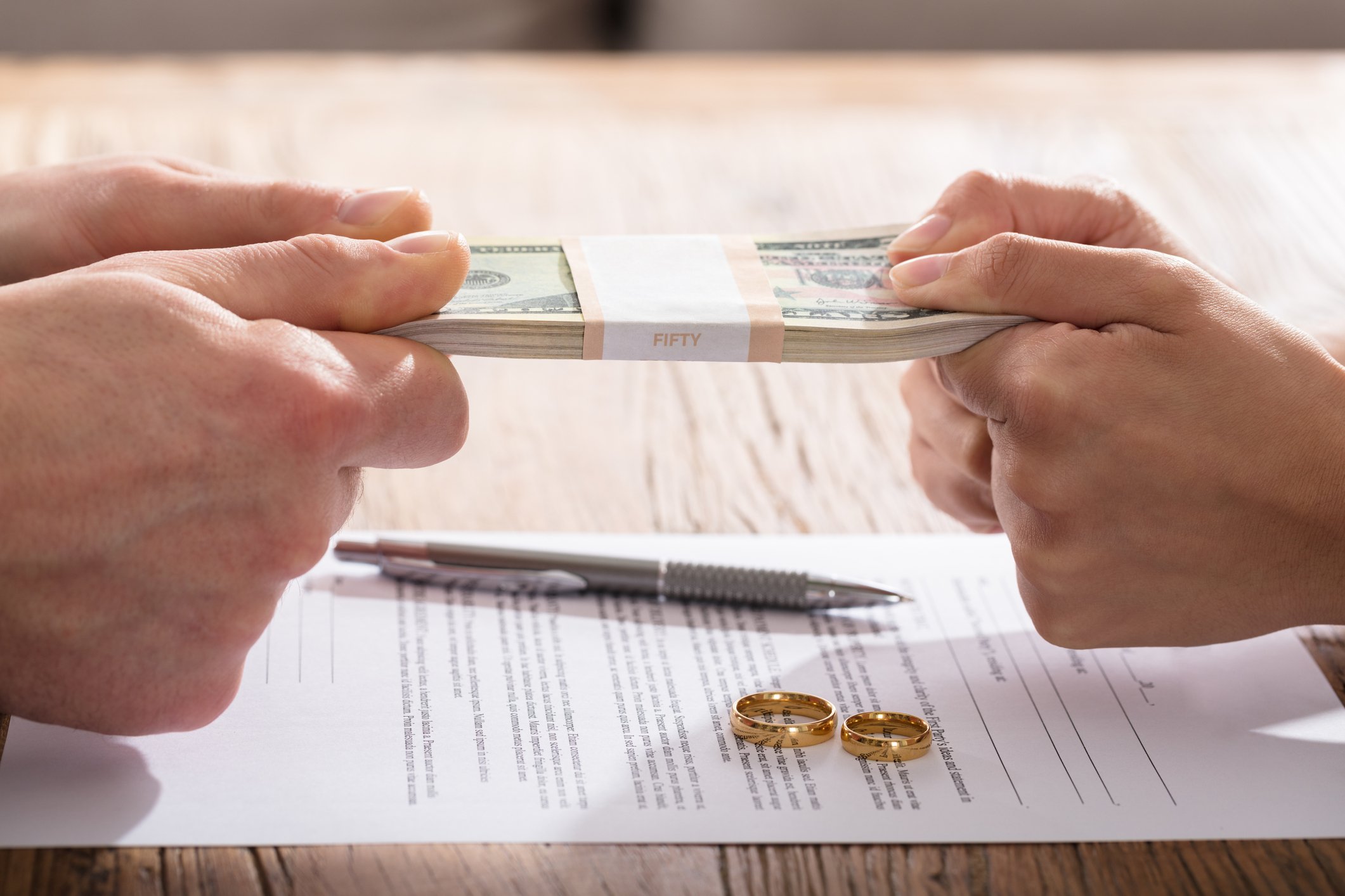 Couple fighting over money over divorce papers