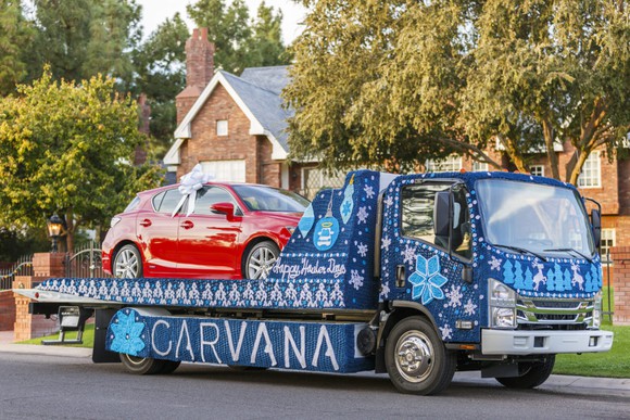 Car being delivered via Carvana flatbed truck
