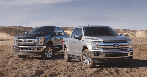 Two full-size Ford pickup trucks, a 2019 Super Duty and a 2019 F-150.