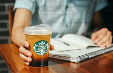 person holding starbucks nitro coffee