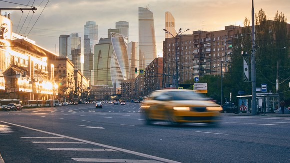 The Moscow skyline with a taxi in the foreground.
