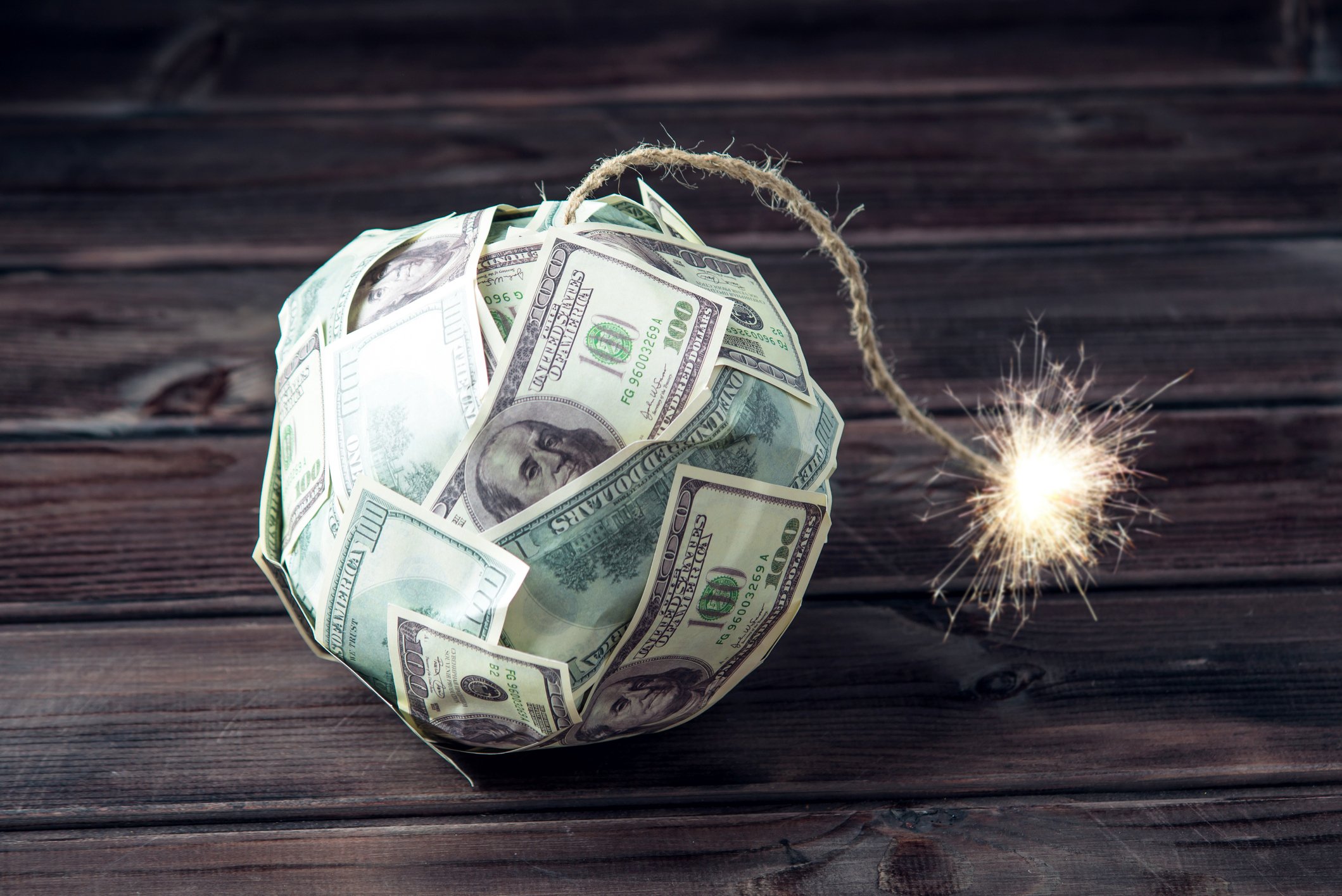 Bomb made of hundred dollarbills with a lit fuse